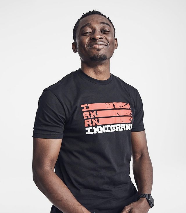 Photo of Bambadjan Bamba wearing a black printed t-shirt with a white background.
